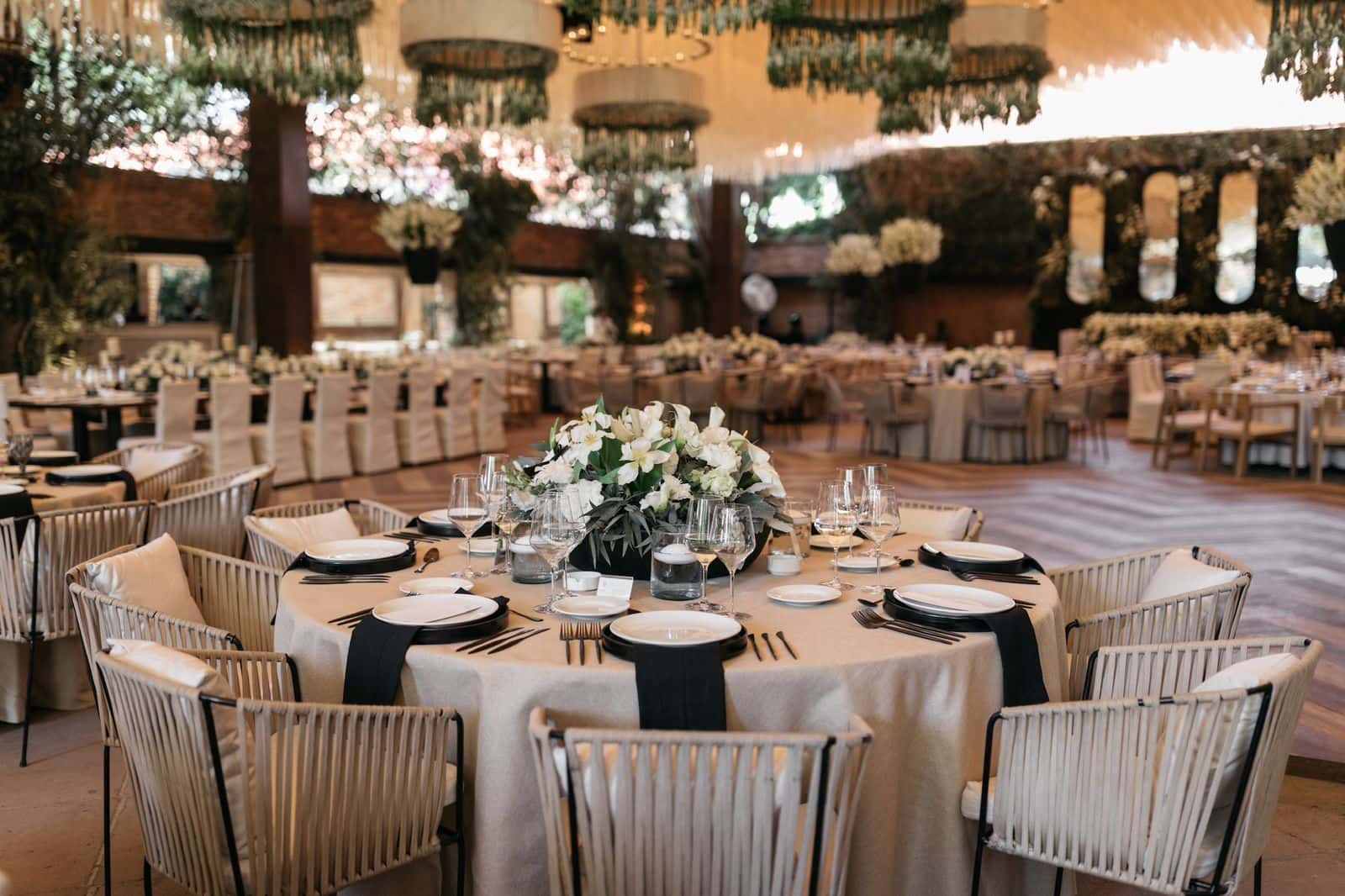 Table with woven chairs and elegant tableware in the Main Hall